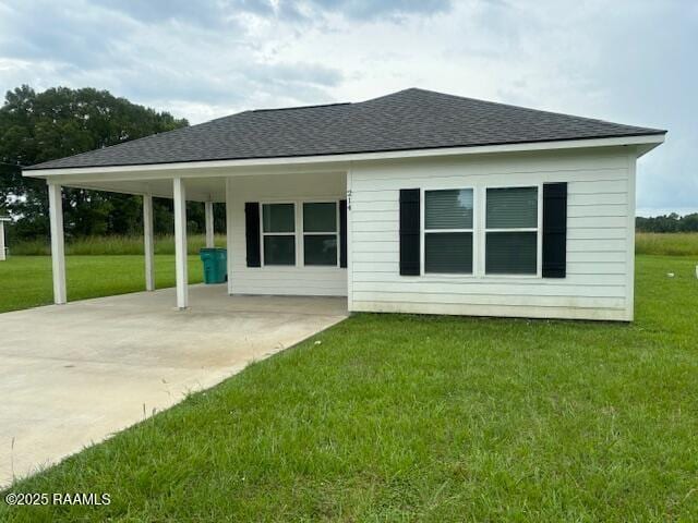 214 Dufilho Rd, Opelousas, LA 70570 - rear view of property featuring a lawn, concrete driveway, a shingled roof, and a carport