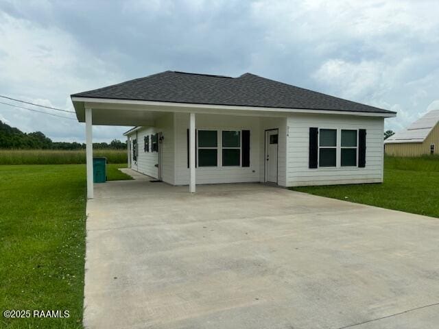 214 Dufilho Rd, Opelousas, LA 70570 - rear view of property with concrete driveway, a yard, and roof with shingles