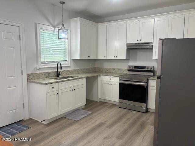 214 Dufilho Rd, Opelousas, LA 70570 - kitchen with stainless steel appliances, under cabinet range hood, a sink, and light wood finished floors