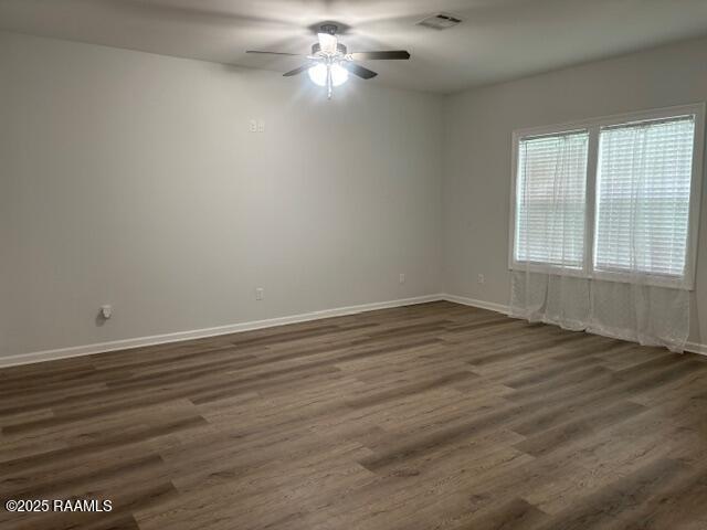 214 Dufilho Rd, Opelousas, LA 70570 - spare room with a ceiling fan, dark wood-style flooring, and baseboards