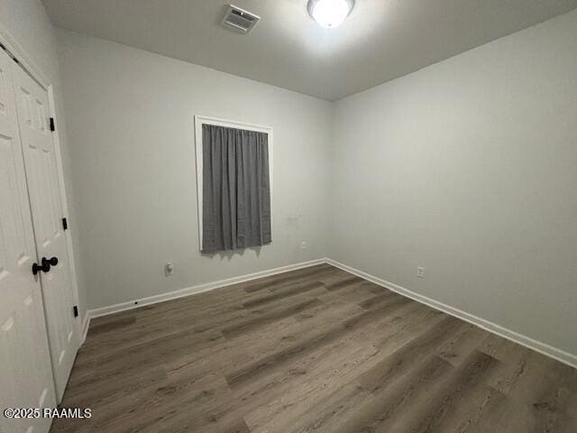 214 Dufilho Rd, Opelousas, LA 70570 - unfurnished bedroom featuring dark wood-style flooring, baseboards, and a closet