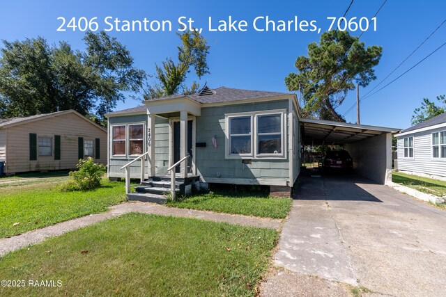 1301 Meadow Dr, Lake Charles, LA 70607 - view of front of home with a front yard, an attached carport, driveway, and a shingled roof