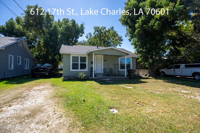 1301 Meadow Dr, Lake Charles, LA 70607 - bungalow-style house featuring covered porch, a front yard, and roof with shingles