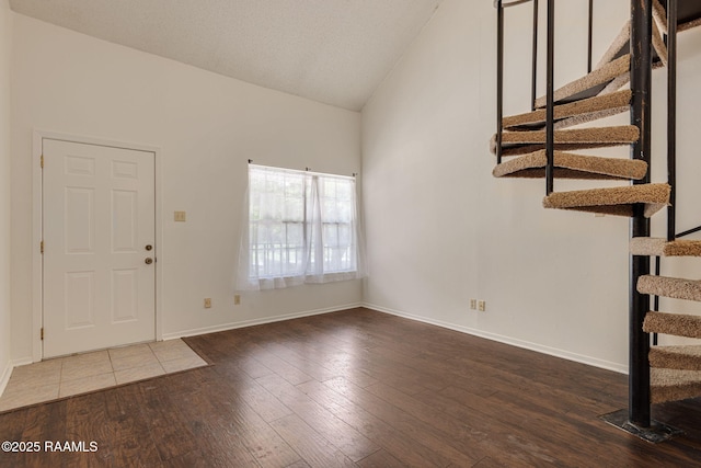 300 Lozes Ave Apt 1503, Lafayette, LA 70508 - entryway with stairway, hardwood / wood-style floors, baseboards, and high vaulted ceiling