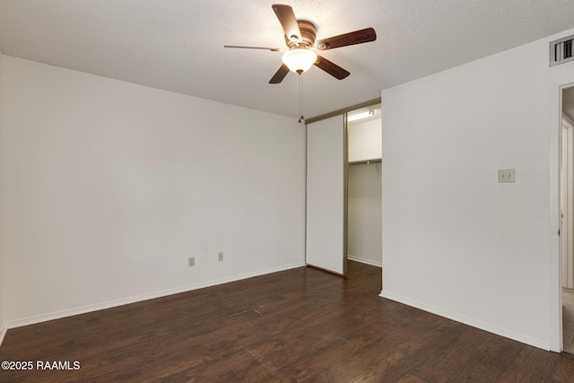 300 Lozes Ave Apt 1503, Lafayette, LA 70508 - unfurnished bedroom featuring dark wood-type flooring, a closet, baseboards, a textured ceiling, and a ceiling fan