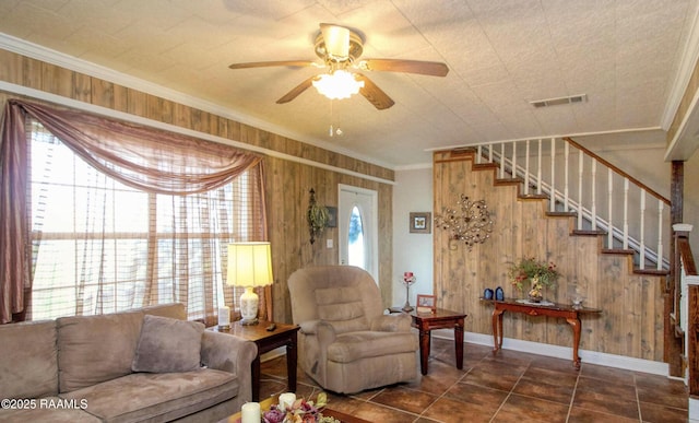 151 Hickory St, Port Barre, LA 70577 - living room featuring crown molding, wooden walls, ceiling fan, stairway, and baseboards