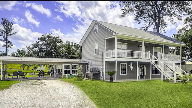 151 Hickory St, Port Barre, LA 70577 - view of front of property featuring metal roof, a front lawn, driveway, stairway, and covered porch
