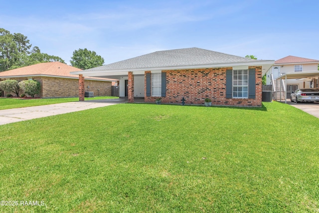 315 Creswell Ave, Scott, LA 70583 - ranch-style house with concrete driveway, a front lawn, brick siding, an attached carport, and central air condition unit