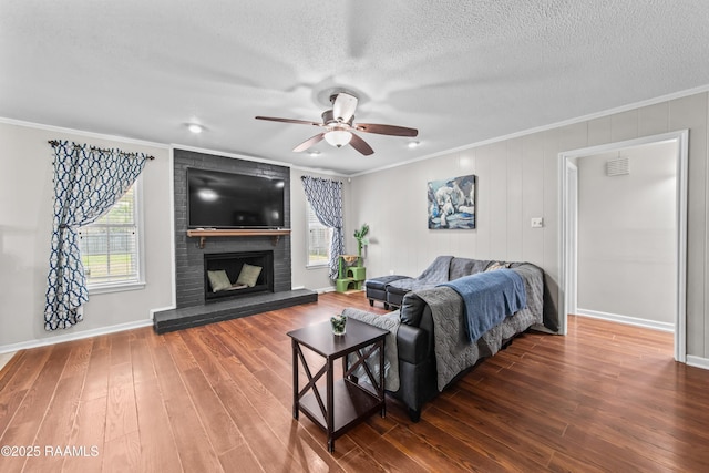 315 Creswell Ave, Scott, LA 70583 - living room with ceiling fan, crown molding, wood finished floors, a brick fireplace, and a textured ceiling