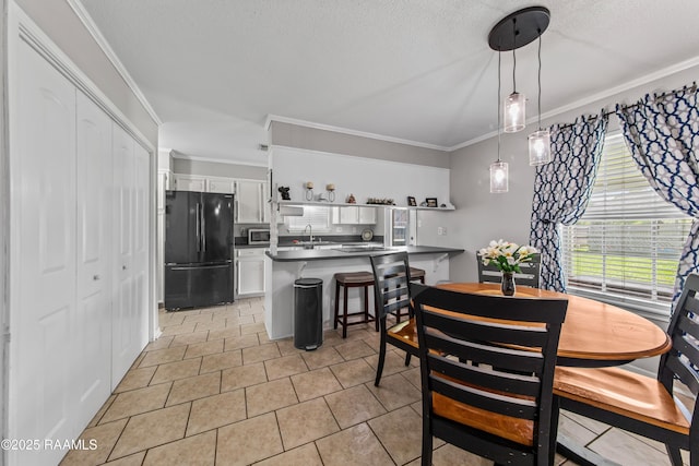 315 Creswell Ave, Scott, LA 70583 - dining space featuring ornamental molding, light tile patterned floors, and a textured ceiling