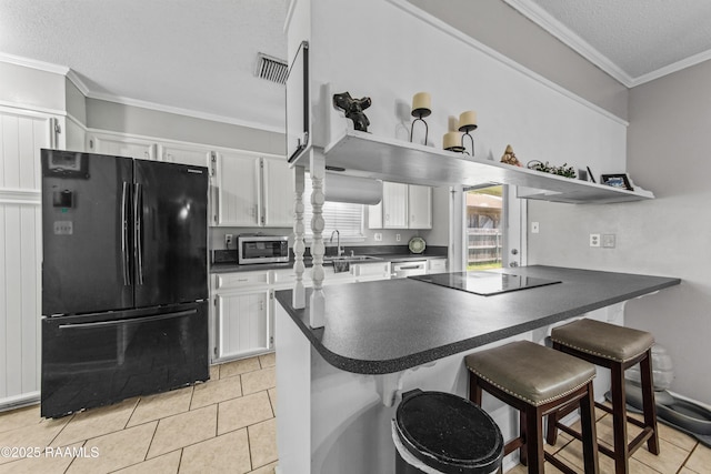 315 Creswell Ave, Scott, LA 70583 - kitchen featuring black appliances, dark countertops, crown molding, white cabinetry, and a sink
