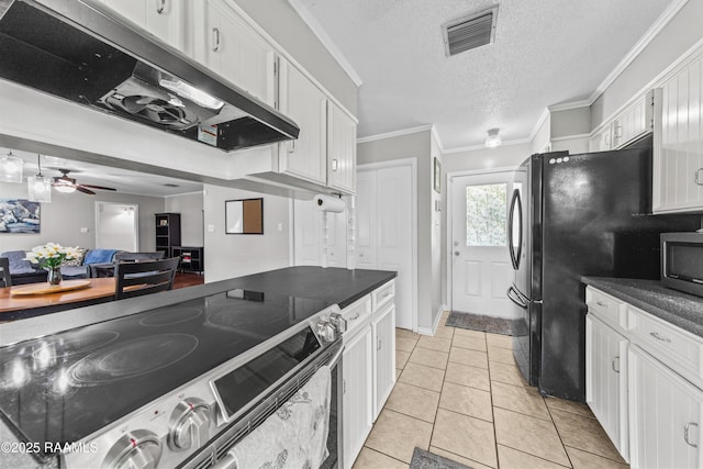 315 Creswell Ave, Scott, LA 70583 - kitchen featuring range hood, appliances with stainless steel finishes, white cabinets, dark countertops, and a textured ceiling