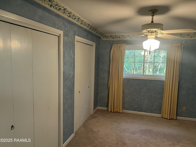 421 Lippi Blvd, Lafayette, LA 70508 - unfurnished bedroom featuring carpet floors, two closets, a ceiling fan, and baseboards