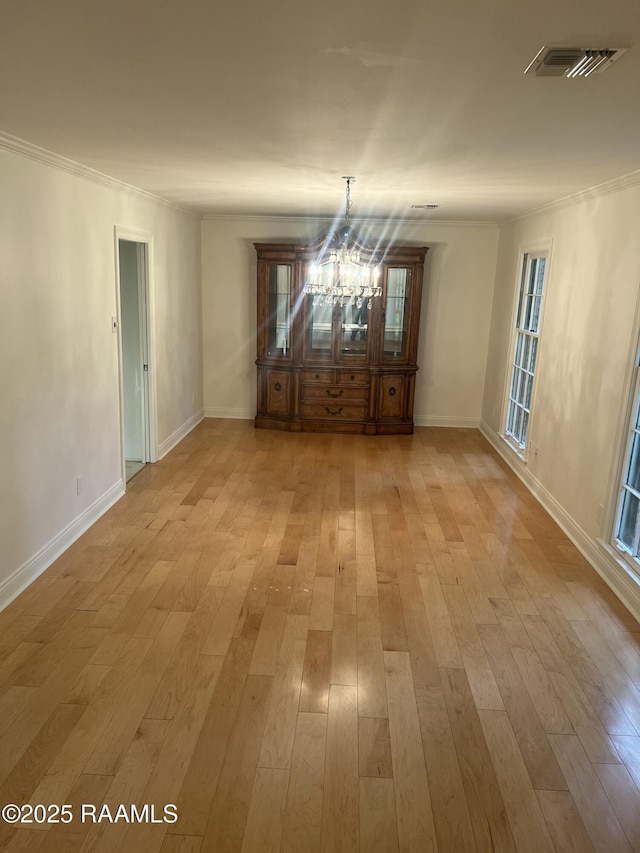 421 Lippi Blvd, Lafayette, LA 70508 - unfurnished dining area with a chandelier, crown molding, light wood-style flooring, and baseboards