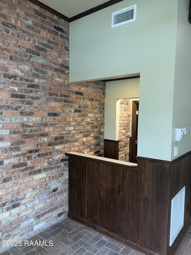 421 Lippi Blvd, Lafayette, LA 70508 - reception area featuring a wainscoted wall, ornamental molding, wood walls, and brick wall
