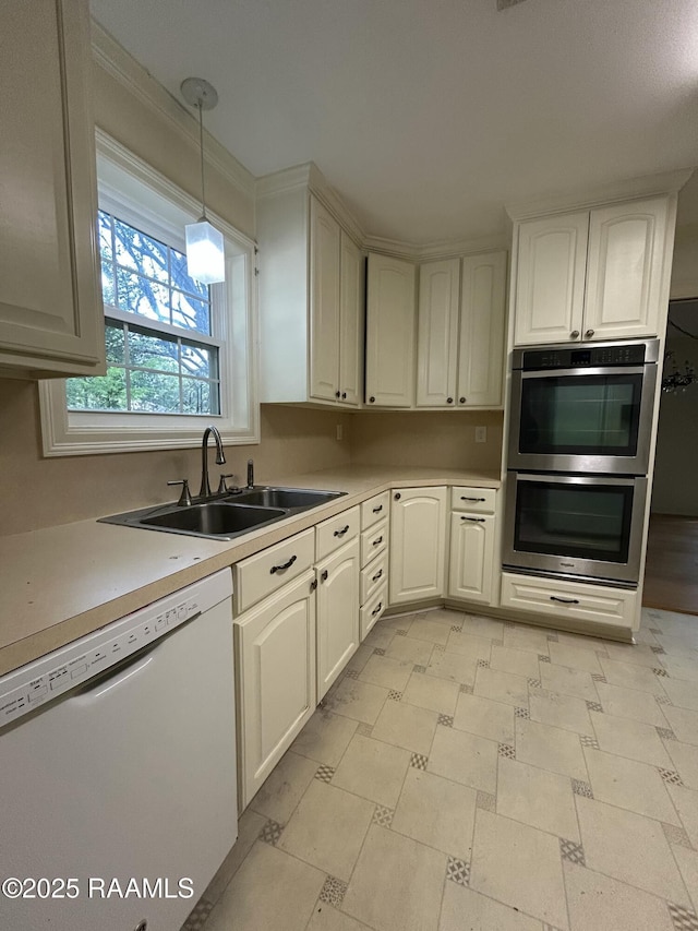 421 Lippi Blvd, Lafayette, LA 70508 - kitchen featuring dishwasher, double oven, a sink, light countertops, and pendant lighting