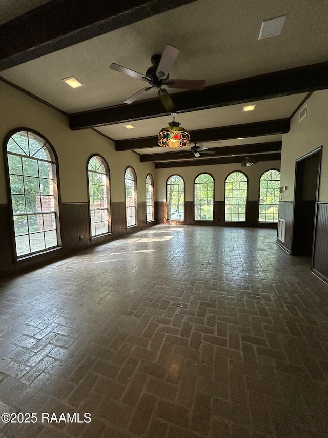 421 Lippi Blvd, Lafayette, LA 70508 - spare room featuring ceiling fan, wainscoting, beamed ceiling, and wood walls