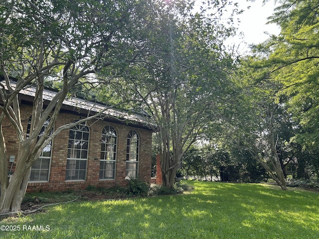 421 Lippi Blvd, Lafayette, LA 70508 - view of side of property with brick siding and a yard