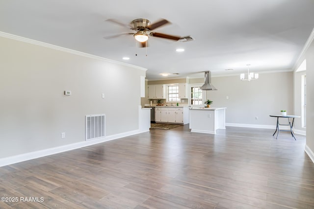 1010 Domingue St, Breaux Bridge, LA 70517 - unfurnished living room featuring ornamental molding, ceiling fan, a chandelier, dark wood-style floors, and recessed lighting