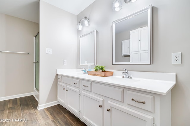 1010 Domingue St, Breaux Bridge, LA 70517 - bathroom featuring double vanity, wood finished floors, and a shower stall