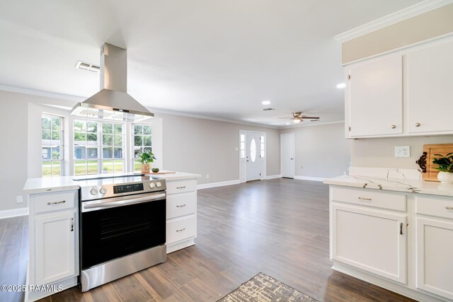 1010 Domingue St, Breaux Bridge, LA 70517 - kitchen with electric stove, crown molding, island exhaust hood, ceiling fan, and white cabinetry