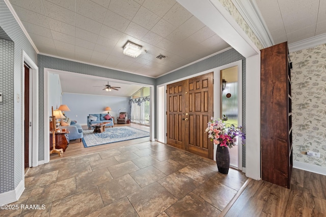 630 W Peach Ave, Eunice, LA 70535 - foyer entrance featuring crown molding, baseboards, wallpapered walls, and ceiling fan