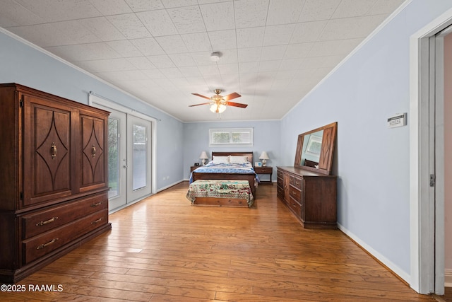 630 W Peach Ave, Eunice, LA 70535 - bedroom featuring crown molding, access to exterior, light wood-style floors, a ceiling fan, and baseboards
