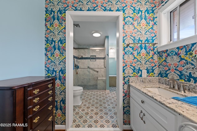 630 W Peach Ave, Eunice, LA 70535 - bathroom with wallpapered walls, vanity, a shower stall, and toilet