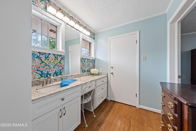 630 W Peach Ave, Eunice, LA 70535 - bathroom featuring crown molding, wood-type flooring, and vanity