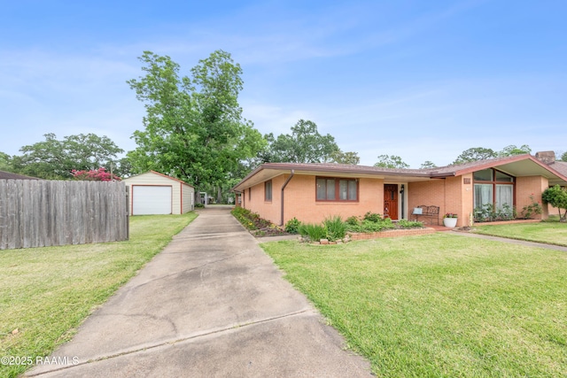 630 W Peach Ave, Eunice, LA 70535 - view of front of house with driveway, a garage, an outdoor structure, and brick siding