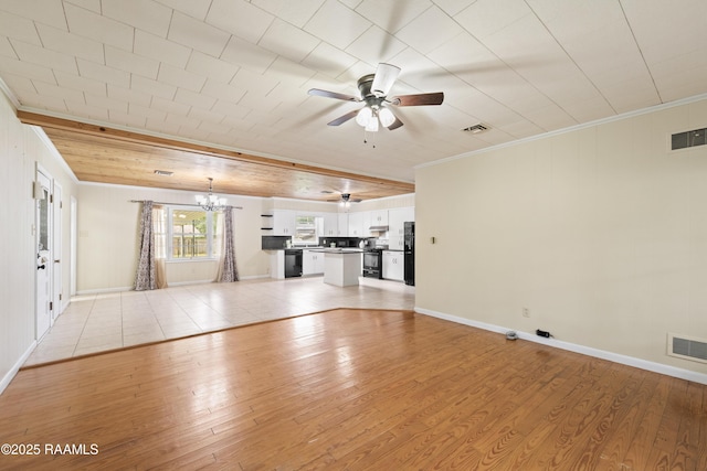 407 N Hebert Ave, Kaplan, LA 70548 - unfurnished living room featuring light wood-type flooring, a ceiling fan, crown molding, a chandelier, and baseboards