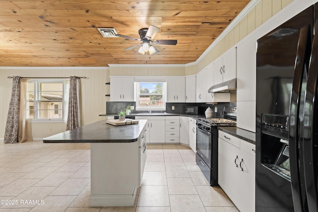 407 N Hebert Ave, Kaplan, LA 70548 - kitchen featuring black appliances, wood ceiling, under cabinet range hood, dark countertops, and light tile patterned flooring