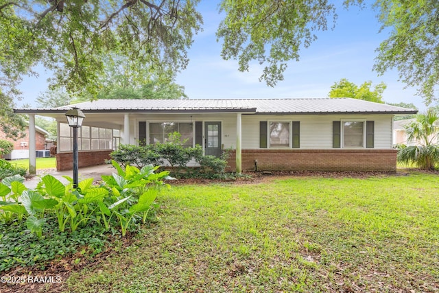 407 N Hebert Ave, Kaplan, LA 70548 - view of front of house with a front yard, brick siding, and an attached carport