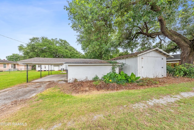 407 N Hebert Ave, Kaplan, LA 70548 - view of property exterior featuring a carport and asphalt driveway