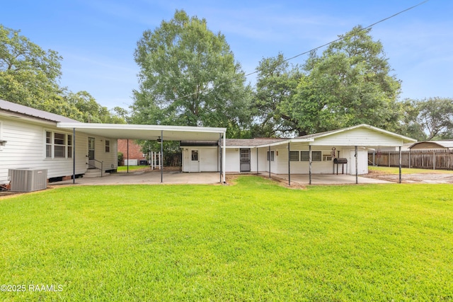 407 N Hebert Ave, Kaplan, LA 70548 - back of house with entry steps, central air condition unit, and an attached carport