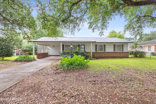 407 N Hebert Ave, Kaplan, LA 70548 - single story home featuring brick siding, a carport, a front lawn, metal roof, and driveway