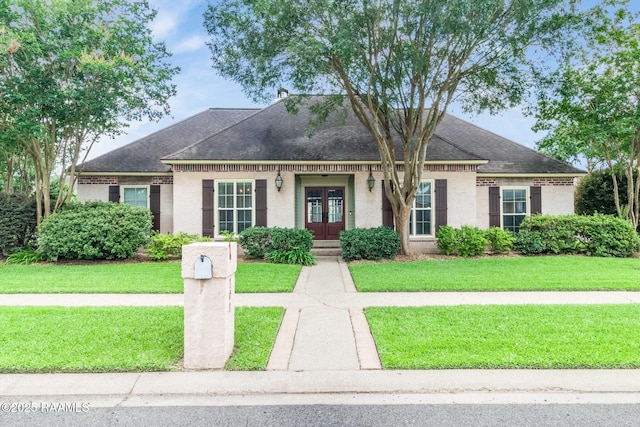 101 Hanover Sq, Lafayette, LA 70508 - view of front facade with french doors, brick siding, and a shingled roof