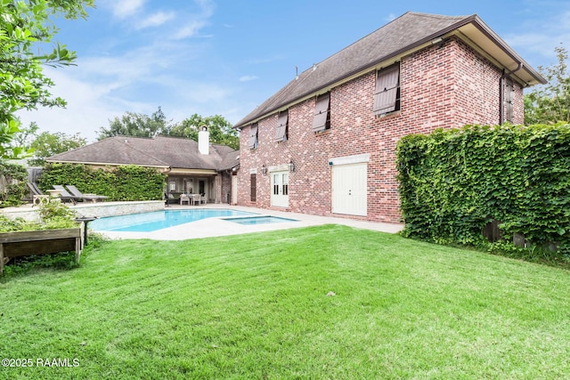 101 Hanover Sq, Lafayette, LA 70508 - rear view of property featuring brick siding, a yard, a chimney, and a patio