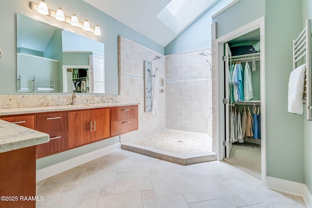101 Hanover Sq, Lafayette, LA 70508 - full bath with vanity, lofted ceiling, a tile shower, a skylight, and a towel warmer