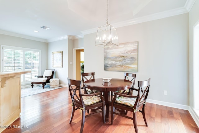 101 Hanover Sq, Lafayette, LA 70508 - dining area with a chandelier, hardwood / wood-style flooring, crown molding, and recessed lighting