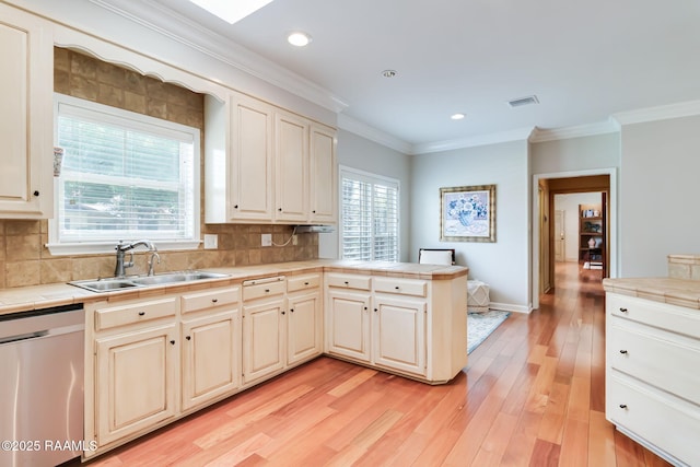 101 Hanover Sq, Lafayette, LA 70508 - kitchen with dishwasher, tile counters, a peninsula, crown molding, and light wood-style floors