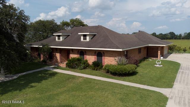1944 Mills St, Scott, LA 70583 - view of front of home with driveway, a front yard, and brick siding