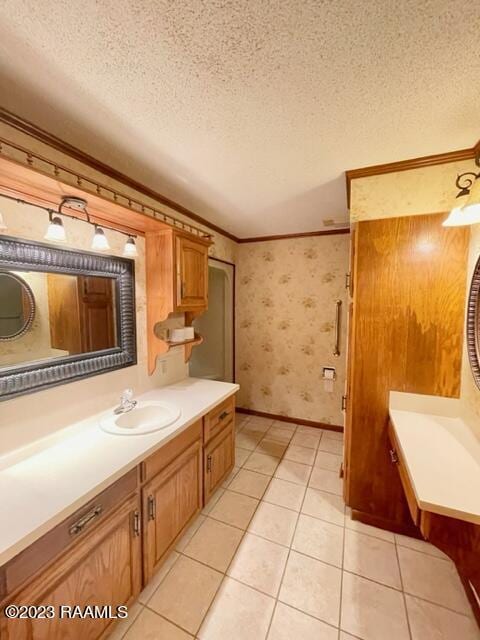 1944 Mills St, Scott, LA 70583 - bathroom with a textured ceiling, ornamental molding, wallpapered walls, vanity, and tile patterned floors