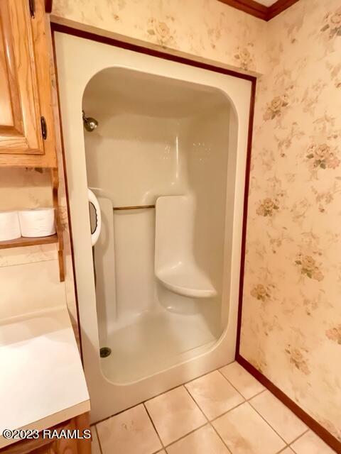 1944 Mills St, Scott, LA 70583 - bathroom featuring vanity, wallpapered walls, tile patterned flooring, baseboards, and a shower