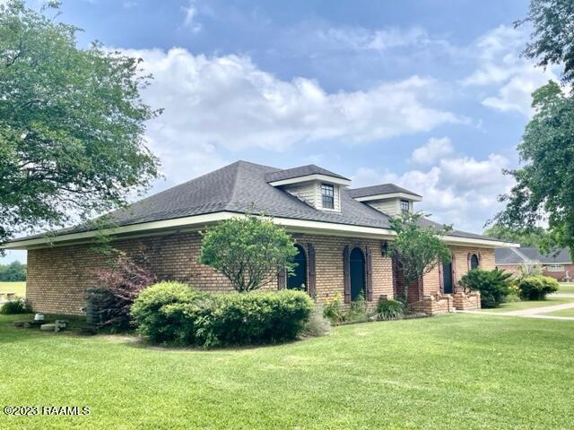 1944 Mills St, Scott, LA 70583 - view of front of home with brick siding and a front yard