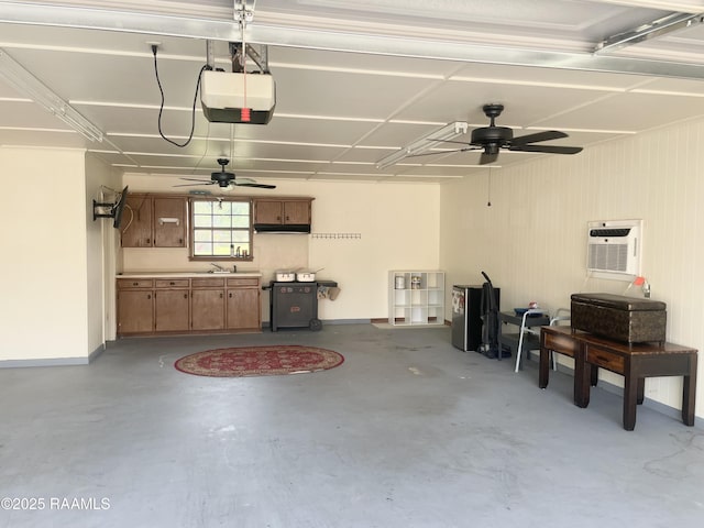 1944 Mills St, Scott, LA 70583 - garage with a garage door opener, ceiling fan, an AC wall unit, a sink, and baseboards
