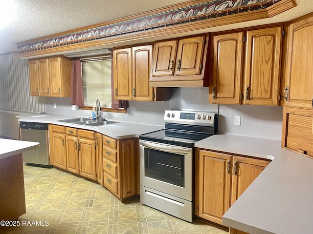 1944 Mills St, Scott, LA 70583 - kitchen with appliances with stainless steel finishes, a sink, light countertops, light floors, and brown cabinetry