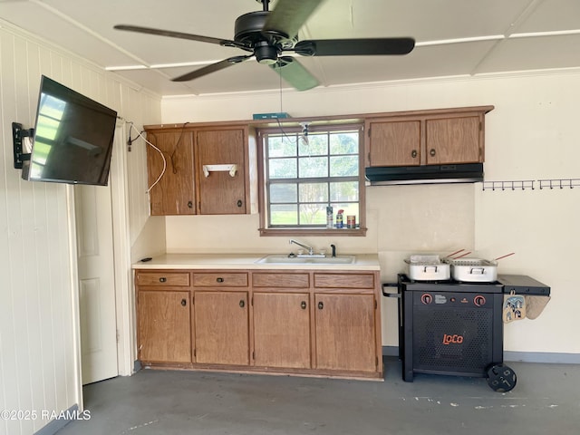 1944 Mills St, Scott, LA 70583 - kitchen featuring concrete floors, light countertops, under cabinet range hood, ceiling fan, and brown cabinets