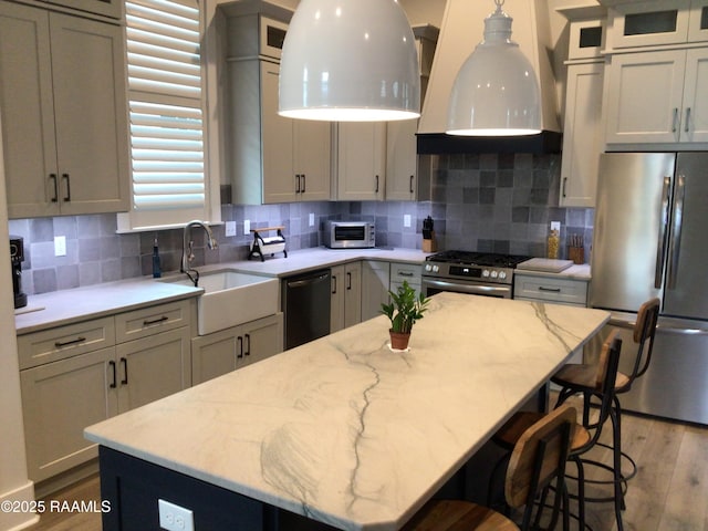 311 Villager Ave Unit C, Scott, LA 70583 - kitchen with stainless steel appliances, a sink, wood finished floors, and light stone countertops