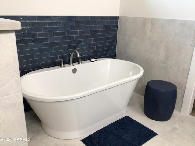 311 Villager Ave Unit C, Scott, LA 70583 - full bathroom featuring tile walls, a freestanding tub, and tile patterned flooring